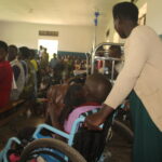 A mother helps her Hydrocephalus conditioned Child during a medical camp at Kitwe Health Centre in October.