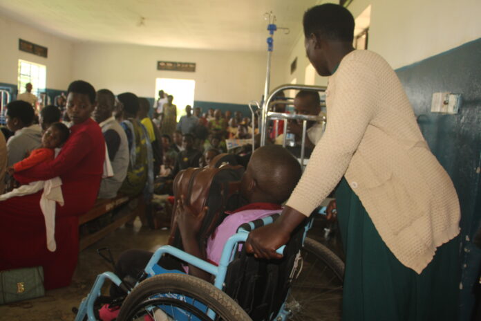 Hydrocephalus camp at Kitwe Ntungamo district A mother helps her Hydrocephalus conditioned Child during a medical camp at Kitwe Health Centre in October.